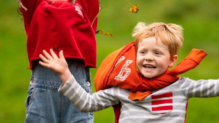 Children enjoying autumn leaves at Sheringham Park, Norfolk